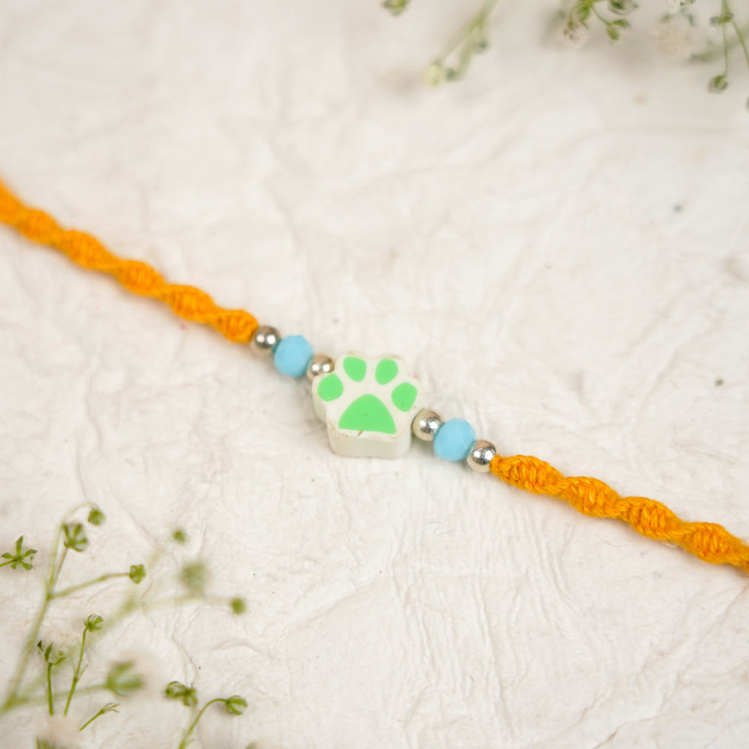Handmade Paw Kids Rakhi With Roli Chawal - Close-up Green Paw Charm