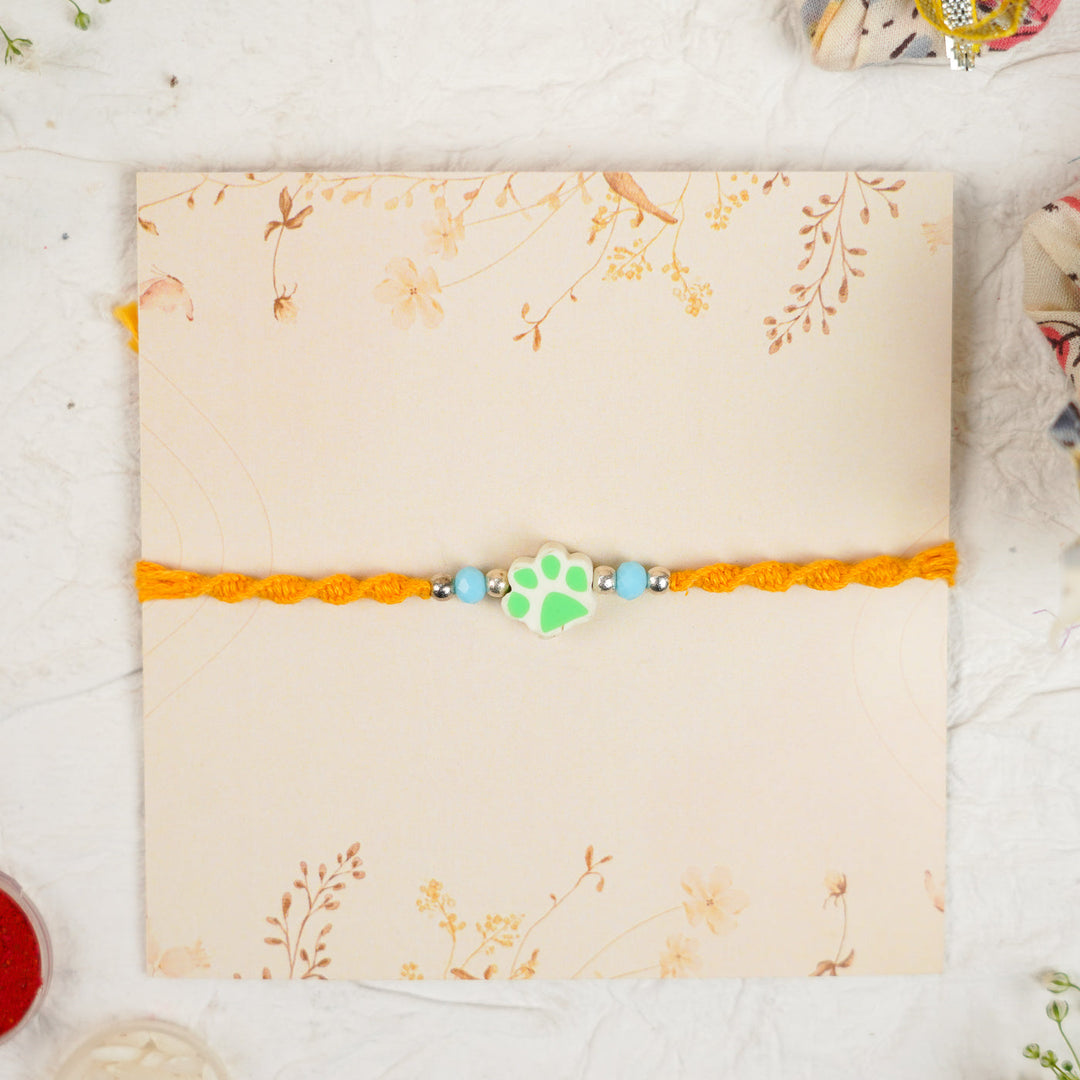 Handmade Paw Kids Rakhi With Roli Chawal - Front View Green Paw Charm