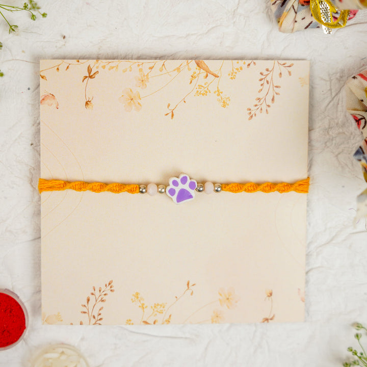 Handmade Paw Kids Rakhi With Roli Chawal - Front View Purple Paw Charm