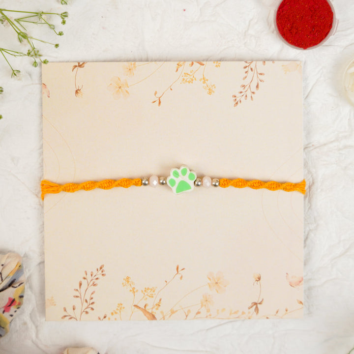 Handmade Paw Kids Rakhi With Roli Chawal - Front View Green Paw Charm (14)