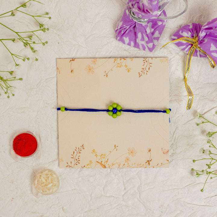 Handmade Beaded Flower Rakhi With Roli Chawal - Flat lay with box and accessories (14)