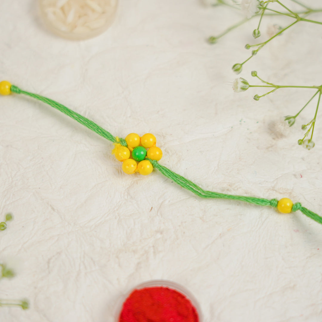Handmade Beaded Flower Rakhi With Roli Chawal - Flat lay with box and accessories (16)