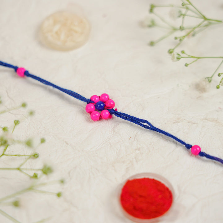 Handmade Beaded Flower Rakhi With Roli Chawal - Flat lay with box and accessories (18)