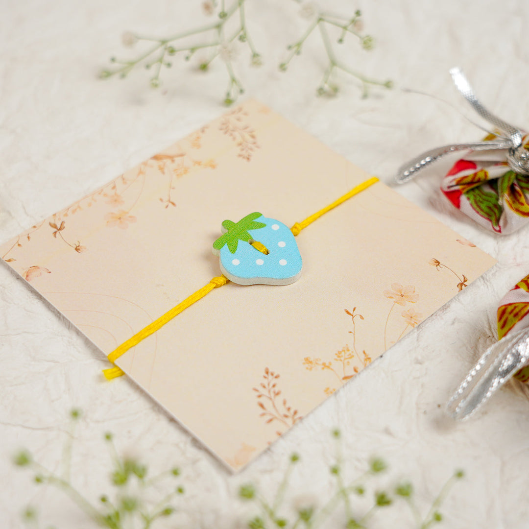 Handmade Strawberry Kids Rakhi With Roli Chawal - Angled Top View (4)