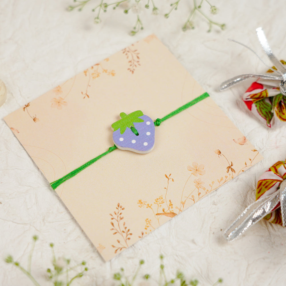 Handmade Strawberry Kids Rakhi With Roli Chawal - Angled Top View