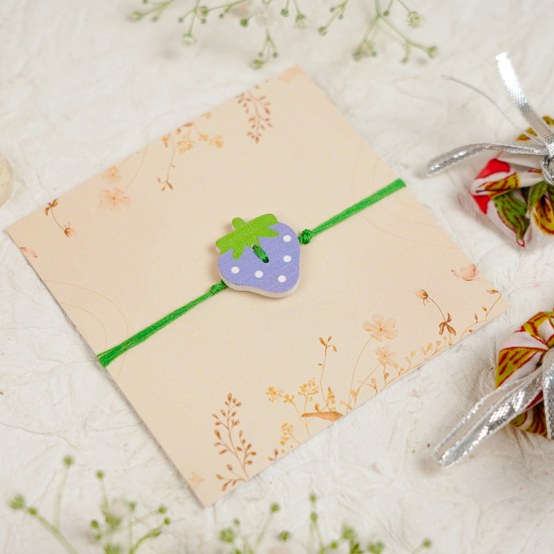 Handmade Strawberry Kids Rakhi With Roli Chawal - Angled Top View