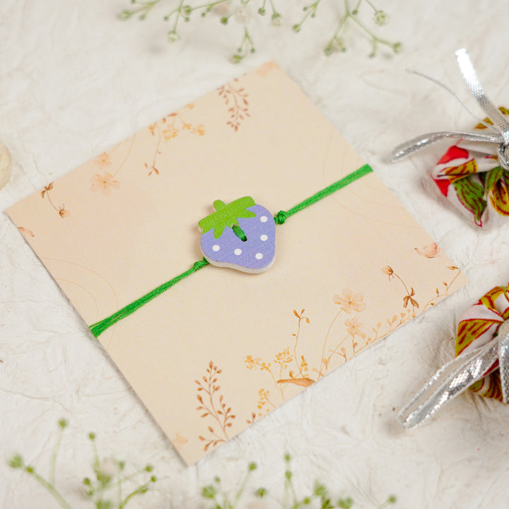 Handmade Strawberry Kids Rakhi With Roli Chawal - Angled Top View