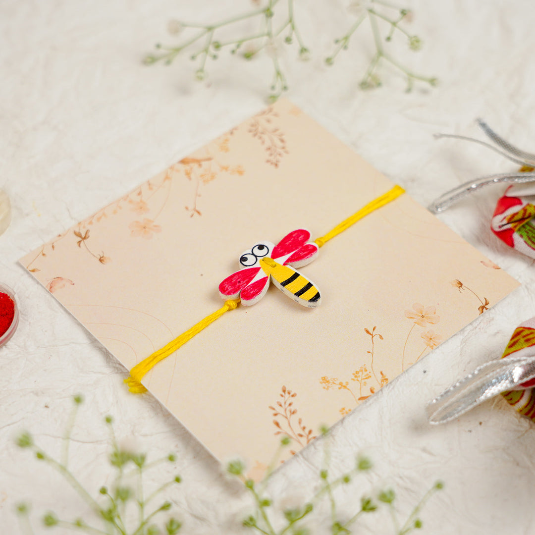 Handmade Dragon Fly Kids Rakhi With Roli Chawal - Angled Close-up View (10)