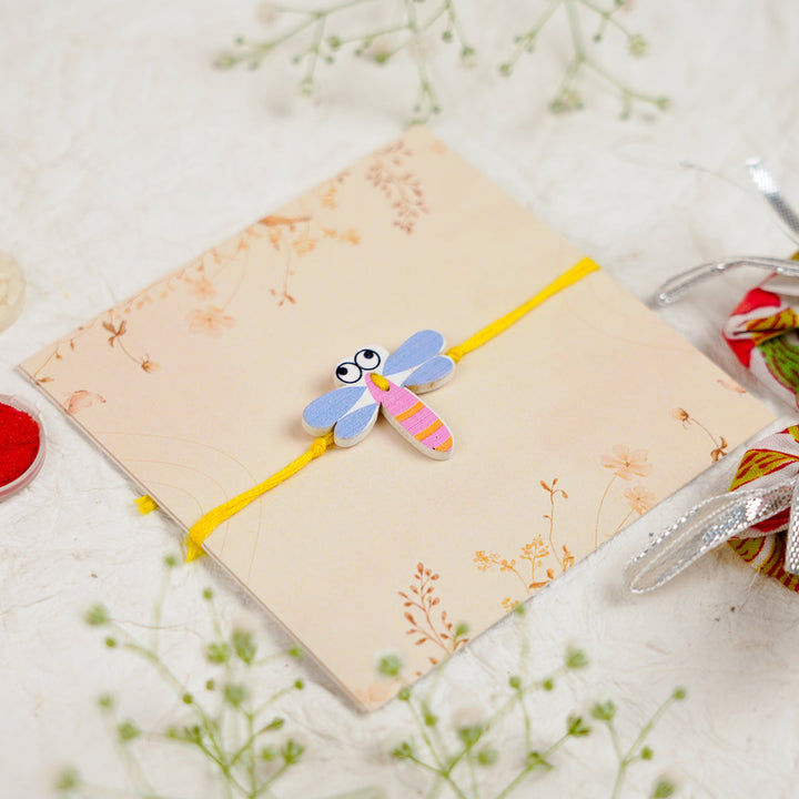 Handmade Dragon Fly Kids Rakhi With Roli Chawal - Angled Close-up View (4)