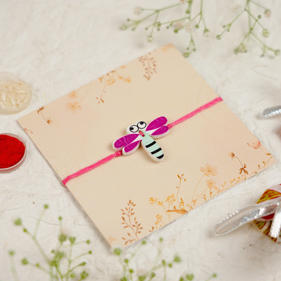 Handmade Dragon Fly Kids Rakhi With Roli Chawal - Angled Close-up View (6)