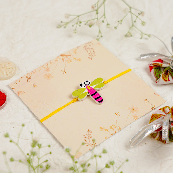 Handmade Dragon Fly Kids Rakhi With Roli Chawal - Angled Close-up View (8)