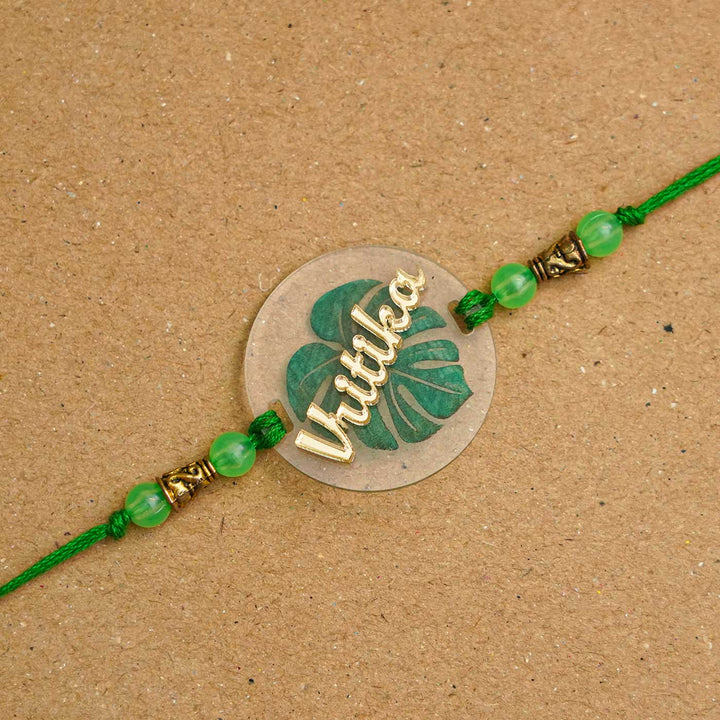 Personalized Handmade Leaf Acrylic Rakhi With Roli Chawal - Close-up of Name Personalized Rakhi