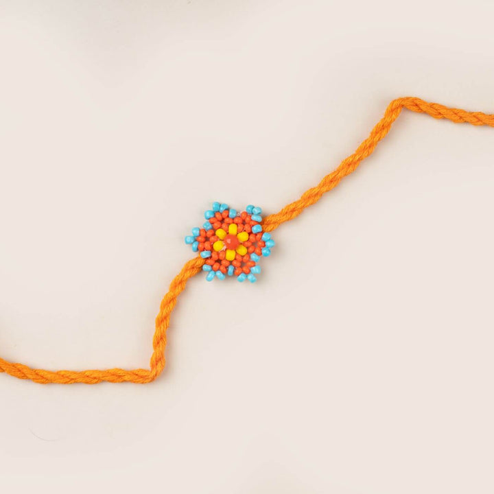 Handcrafted Glass Beads Sitara Rakhi 7 - Close-up of orange rakhi design