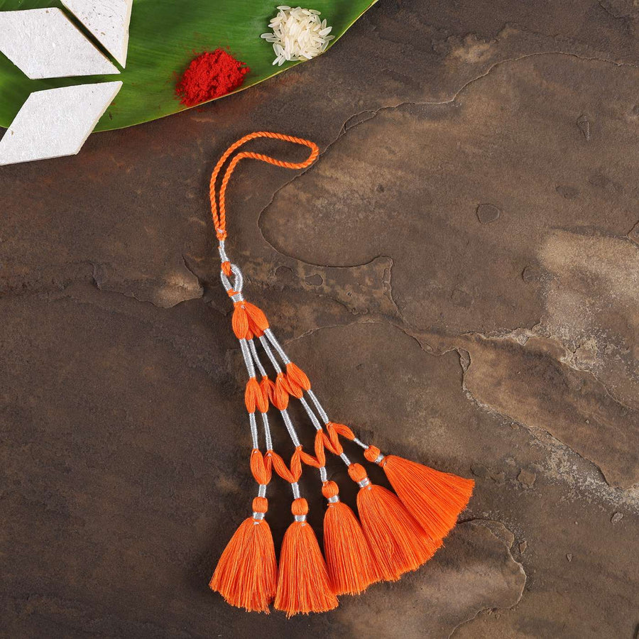 Handmade Tassel Cotton Lumba Rakhi For Bhabhi With Roli Chawal - Flat Lay Display