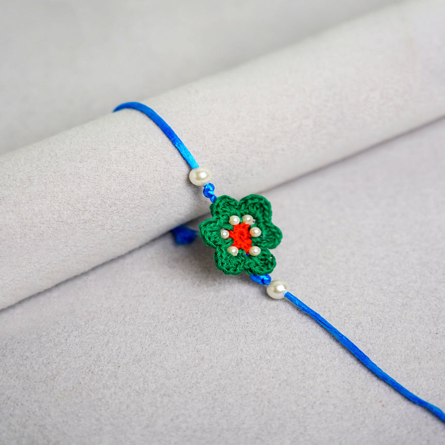 Floral Handcrafted Crochet Rakhi With Roli Chawal For Kids 4 - Close-up of single bracelet