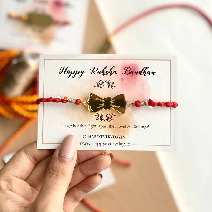 Handcrafted Golden Acrylic Rakhi With Roli Chawal 1 - Front View Holding Card