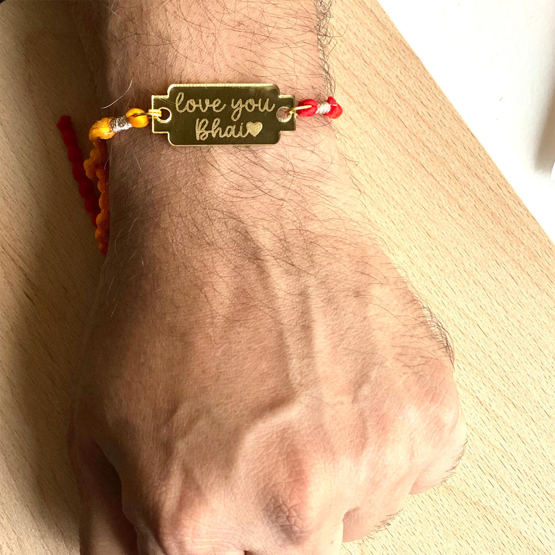 Handcrafted Golden Acrylic Rakhi With Roli Chawal 1 - Worn on Wrist Close-up