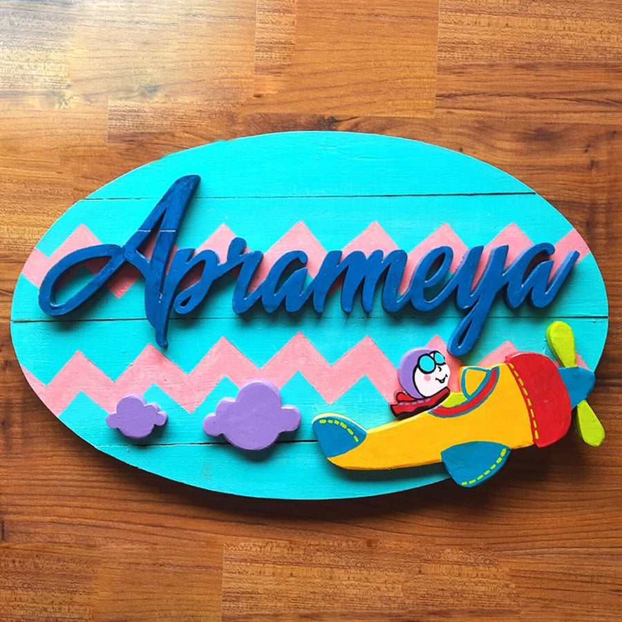 Hand Painted Personalized Plane Themed Wooden Name Plate - Top Down View on Wood Surface