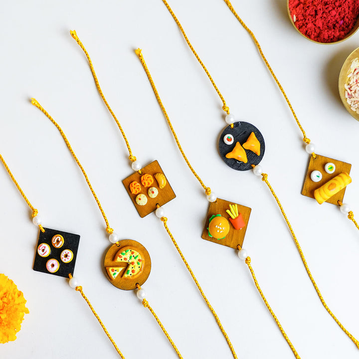 Handmade Food Themed Clay Rakhi 2 - Group display of Rakhi variations