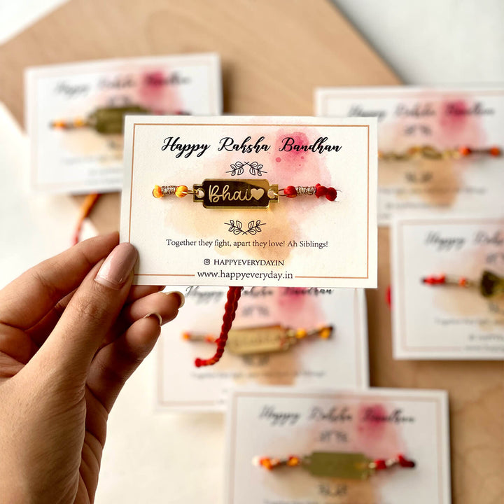 Handcrafted Golden Acrylic Rakhi With Roli Chawal 1 - Front View with Hand Holding