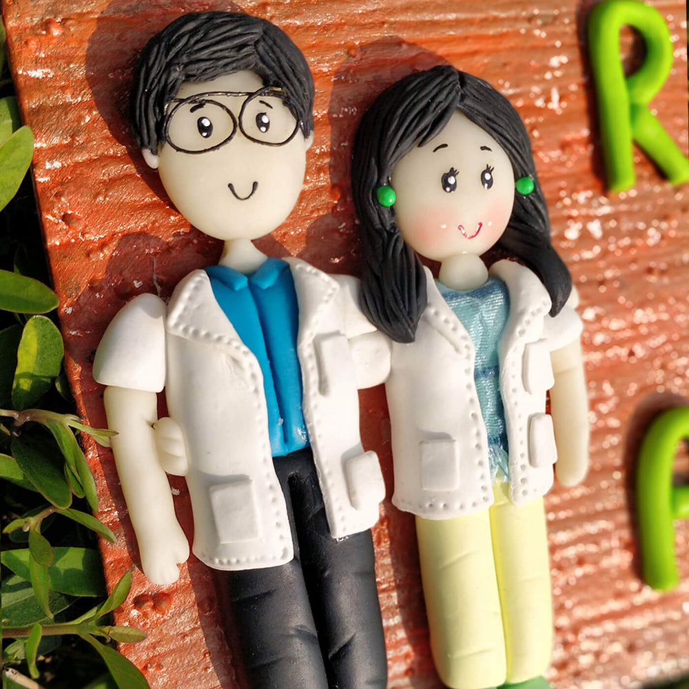 Handcrafted Personalized Clay Caricature Couple Name Plate For Doctors - Close-up of Custom Figurines