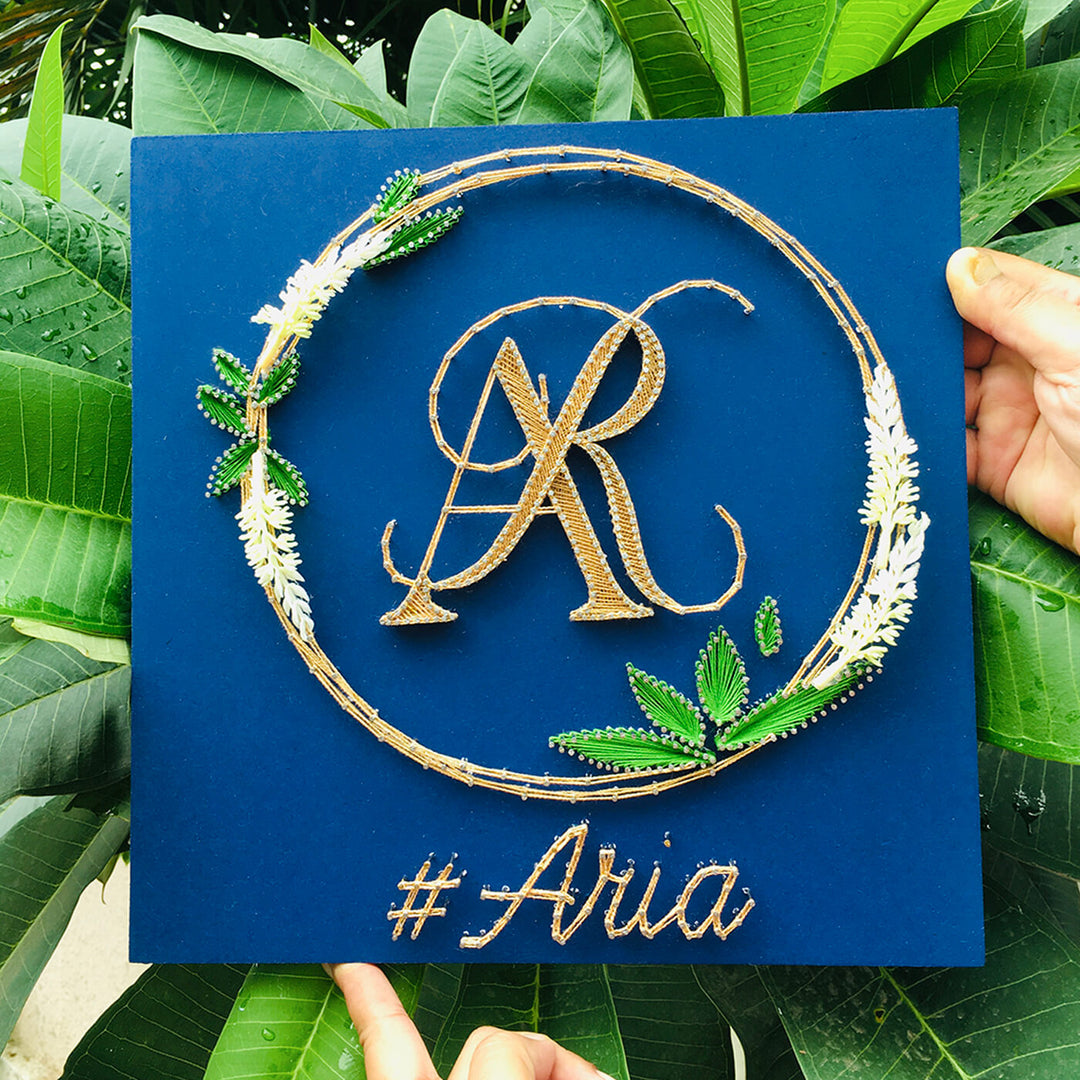Wedding Couple Initials String Art With Leaf Wreath - Front View Held by Hands
