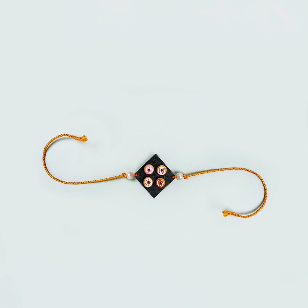 Handmade Food Themed Clay Rakhi 5 - Flat lay of single rakhi