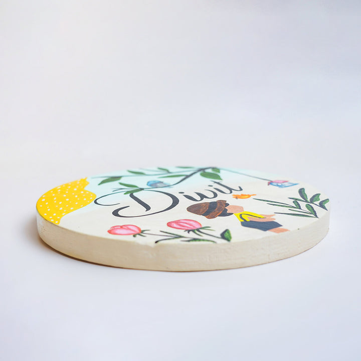 Handpainted Round Wooden Kids Name Plate - Angle Showing Thickness and Design