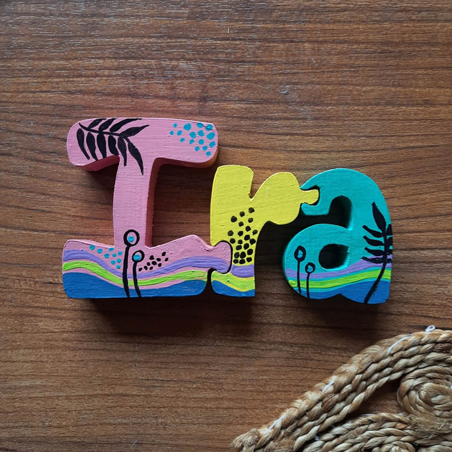 Hand Painted Interlockable Beach Themed Wooden Self Standing Name Plate - Top View on Wooden Surface