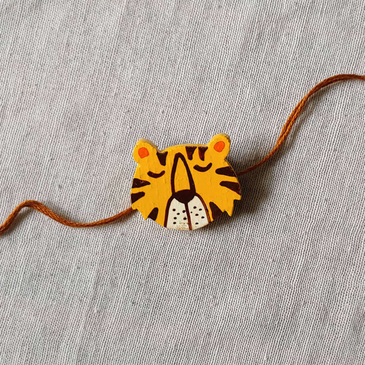 Handpainted Quirky Wooden Rakhi With Roli Chawal 9 - Front View on Thread