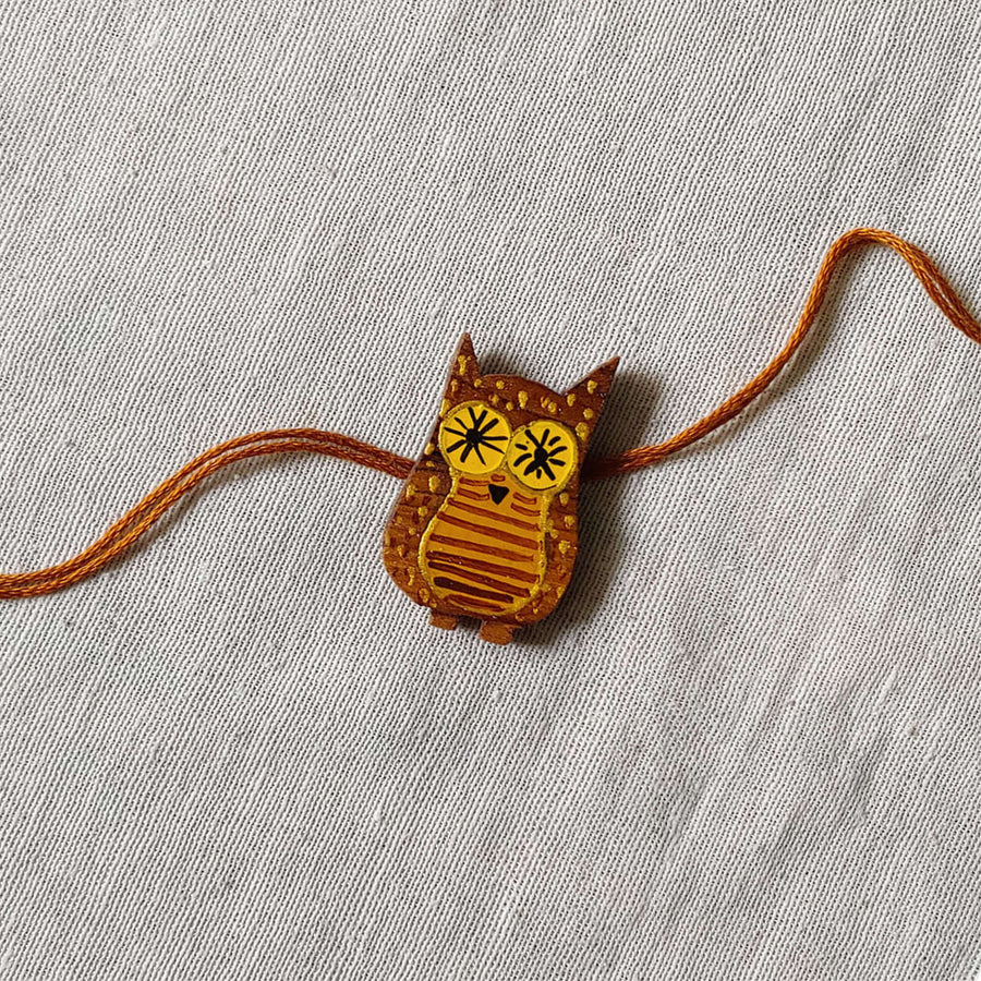 Handpainted Quirky Wooden Rakhi With Roli Chawal 10 - Close-up of Owl Charm