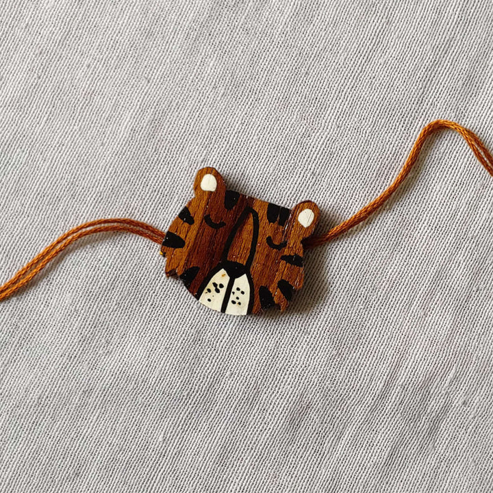 Handpainted Quirky Wooden Rakhi With Roli Chawal 3 - Close-up of Tiger Rakhi