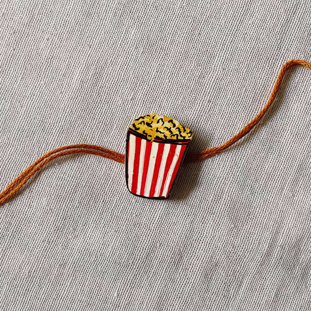 Handpainted Quirky Wooden Rakhi With Roli Chawal 5 - Close-up on Popcorn Rakhi