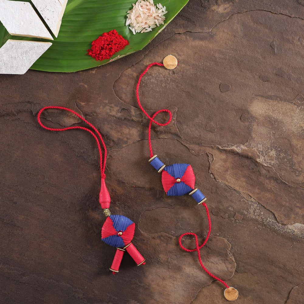 Handmade Beaded Paper Cushion Bhaiya Bhabhi Rakhi With Roli Chawal Set Of 2 - Flat Lay with Decorative Elements