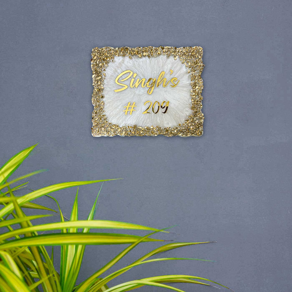 Personalized Resin White And Gold Crystals Theme Name Plate - Mounted on Wall with Plant Nearby