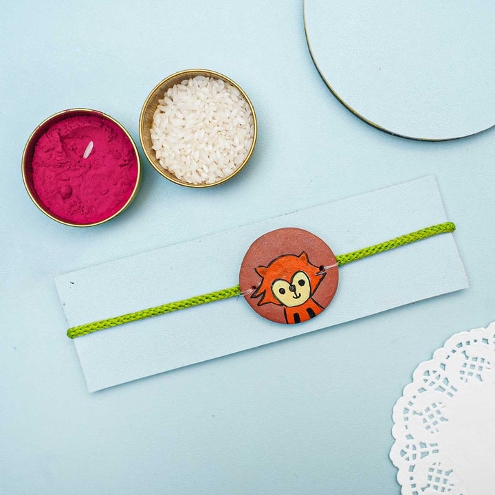Hand Painted Fox Terracotta Rakhi With Roli Chawal For Kids - Styled with Rakhi and accessories