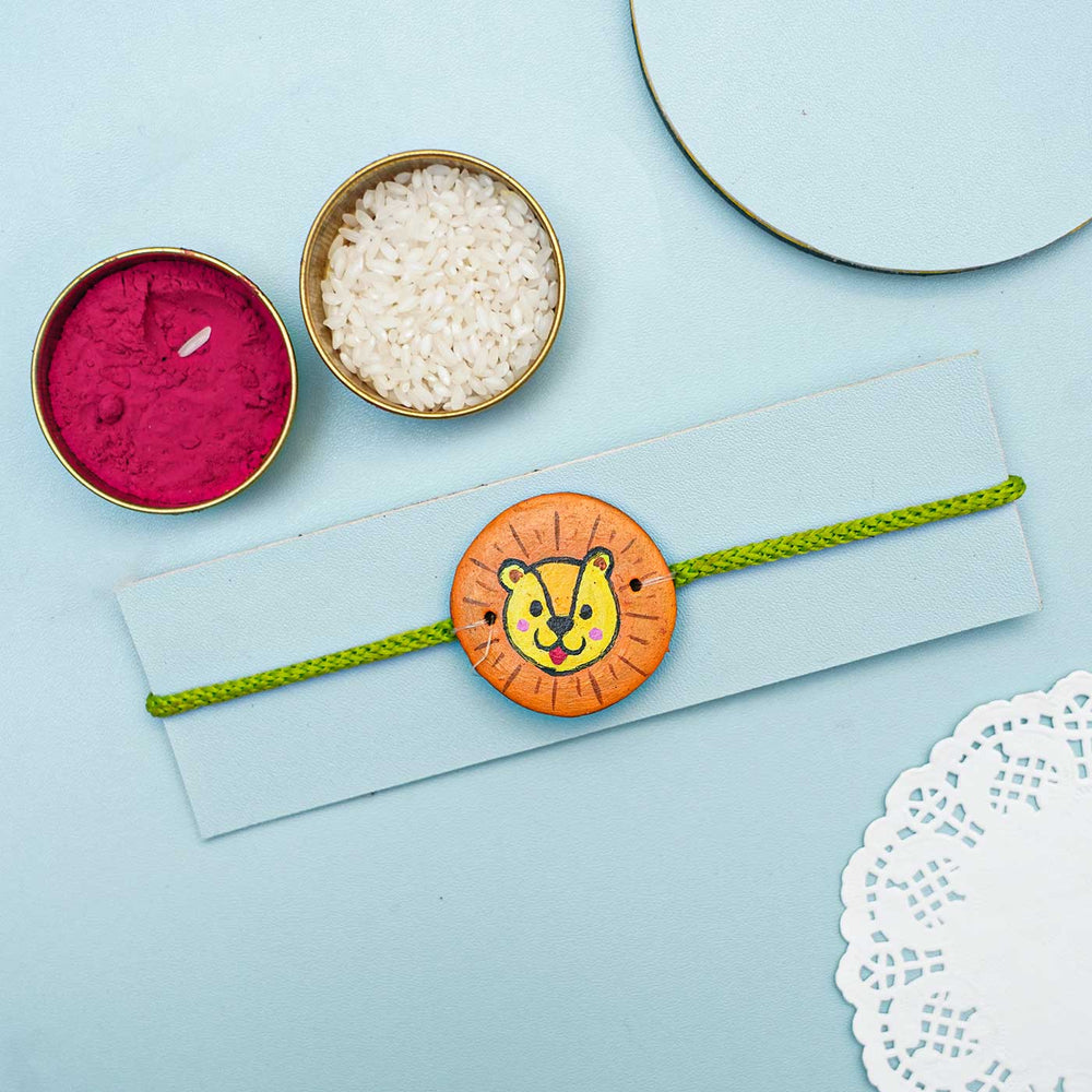 Hand Painted Panther Terracotta Rakhi With Roli Chawal For Kids - Styled with Traditional Elements