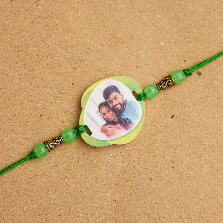 Photo Personalized Handmade Photo Acrylic Rakhi With Roli Chawal - Close-up of green photo rakhi