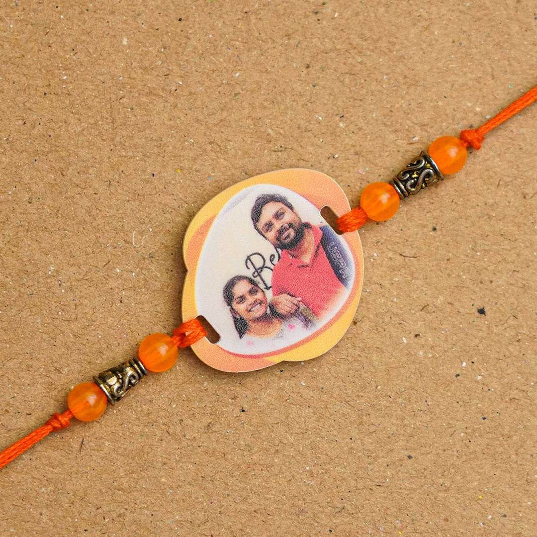 Photo Personalized Handmade Photo Acrylic Rakhi With Roli Chawal - Close-up of personalized photo rakhi
