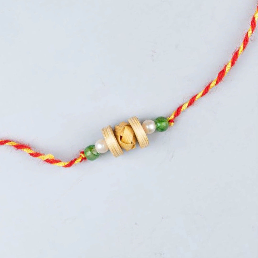 Ecofriendly Bamboo Rakhi With Roli Chawal 6 - Single rakhi close-up with green beads