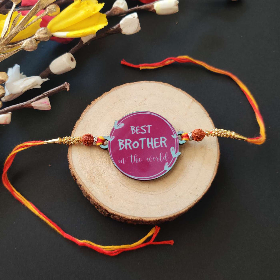 Handmade Printed Best Brother In World Wooden Rudraksha Rakhi With Roli Chawal - Front View on Wood Slab
