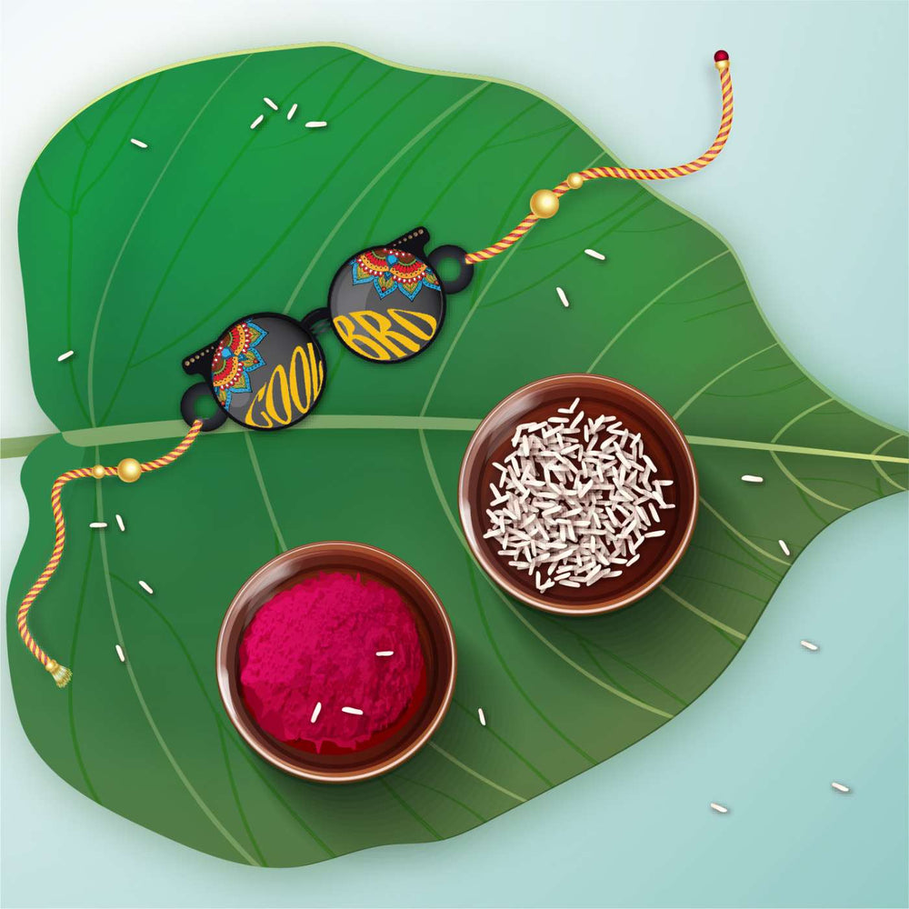 Handmade Printed Cool Bro Wooden Rudraksha Rakhi With Roli Chawal - Flat Lay on Leaf with Bowls