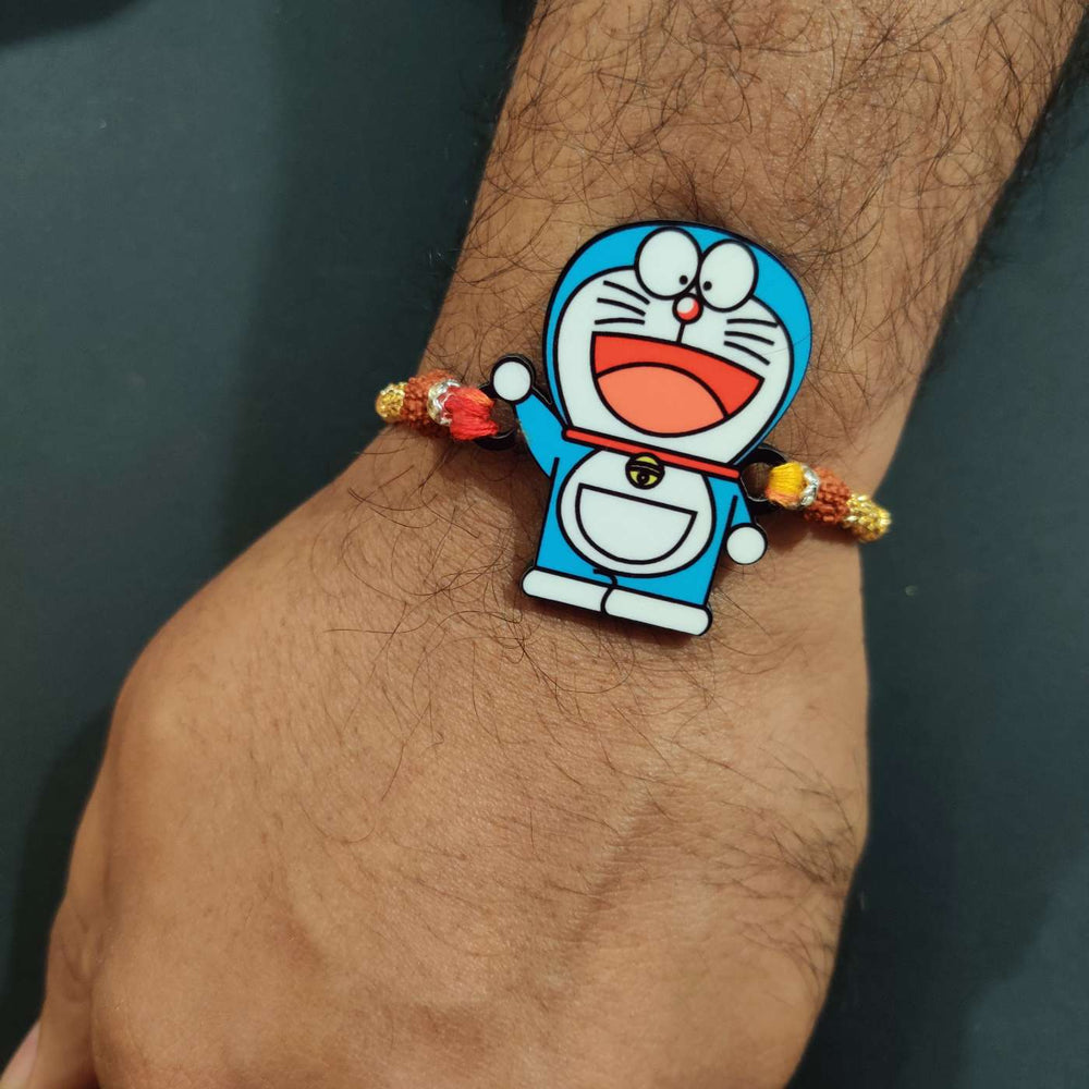 Handmade Printed Doraemon Wooden Rudraksha Rakhi With Roli Chawal - Worn on Wrist Close-up