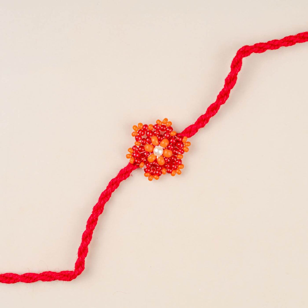 Handcrafted Glass Beads Sitara Rakhi 7 - Close-up of red and orange rakhi