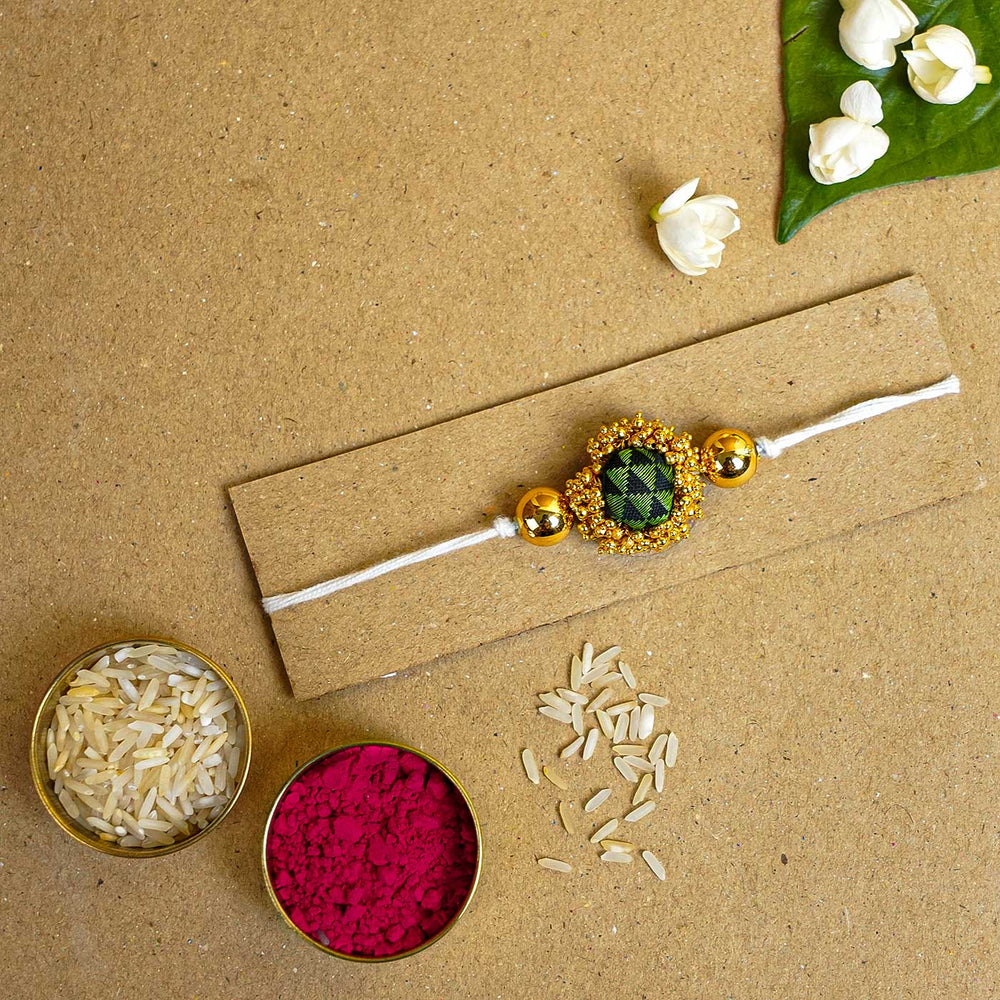 Handmade Green And Gold Fabric Rakhi With Roli Chawal - Rakhi with traditional accessories