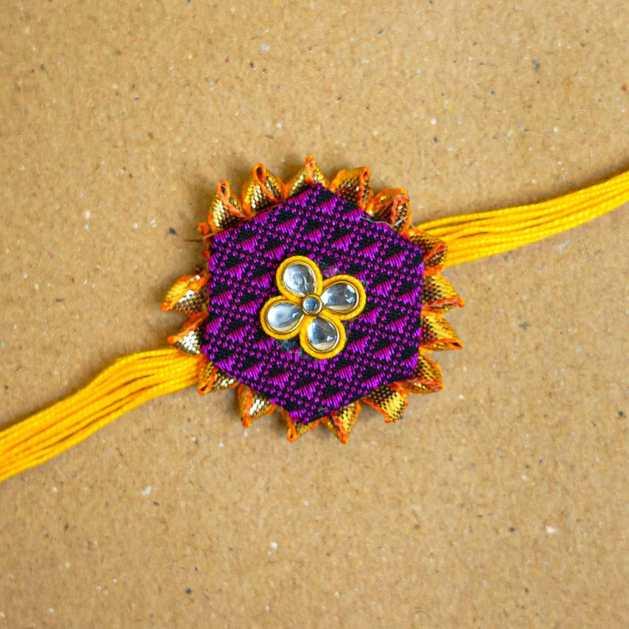 Handmade Purple Hexagon Fabric And Mdf Rakhi With Roli Chawal - Close-up of Rakhi design