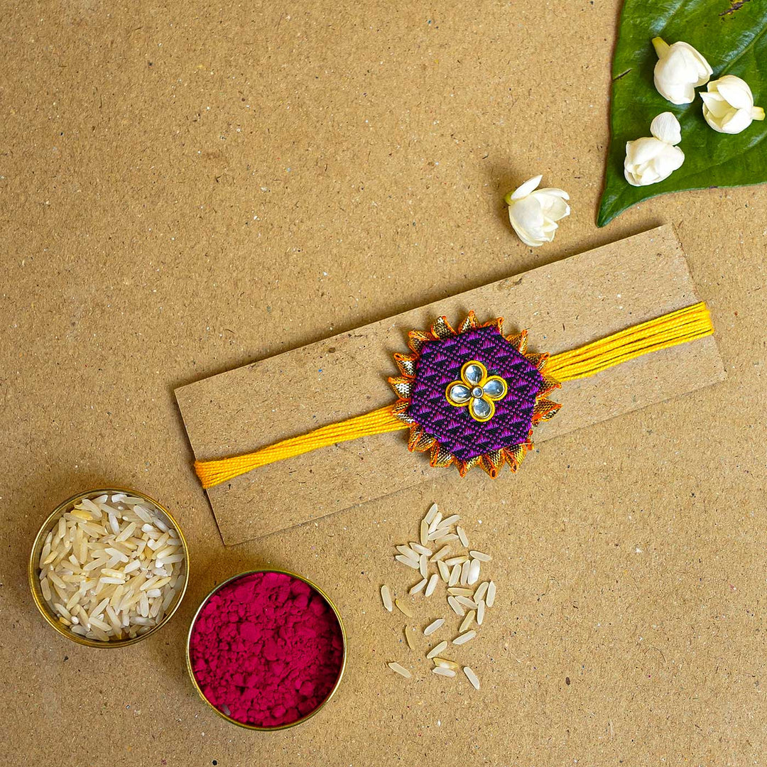 Handmade Purple Hexagon Fabric And Mdf Rakhi With Roli Chawal - Rakhi on display card with props