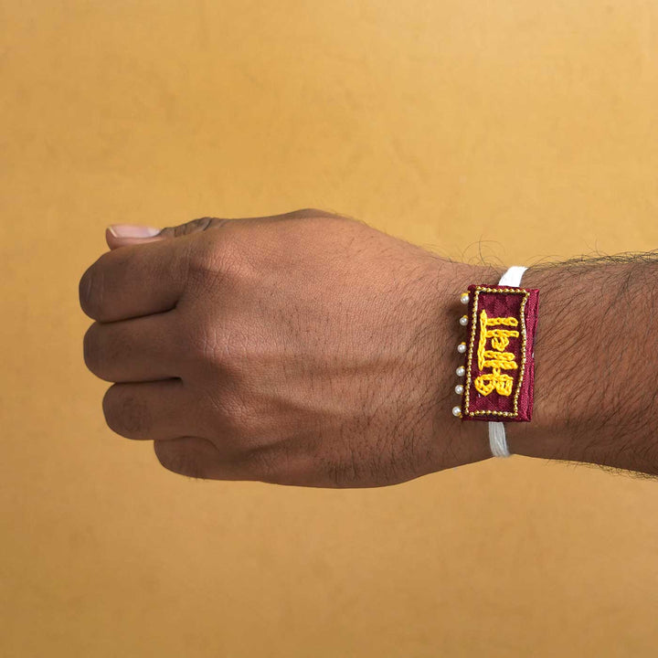 Handmade Bhava Fabric And Mdf Rakhi With Roli Chawal - On Wrist Display