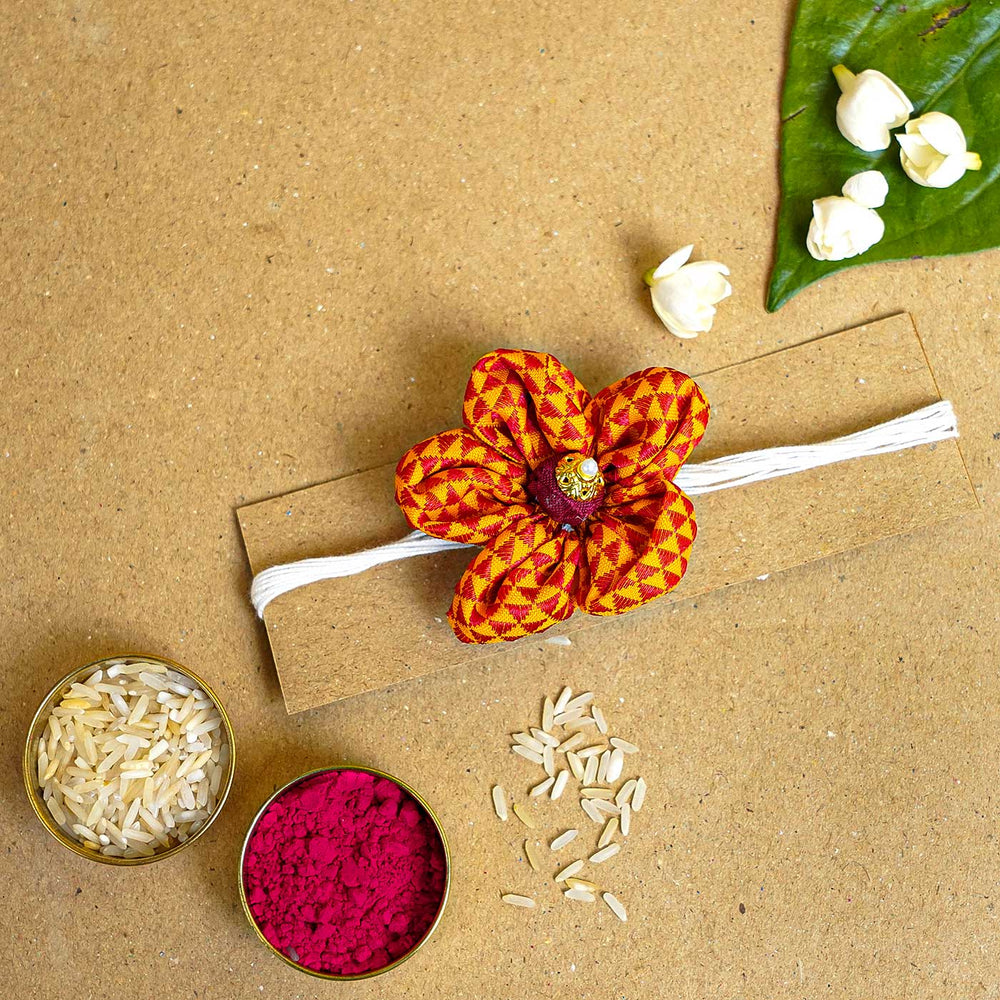 Handmade Orange And Red Floral Fabric Rakhi With Roli Chawal - Flower Rakhi with Festival Items