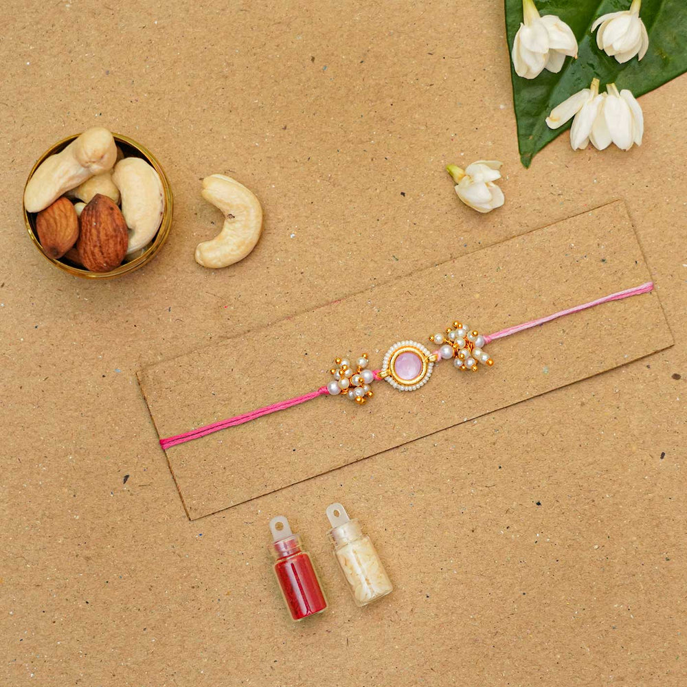 Reusable Resin Kundan Rakhi With Roli Chawal For Brother - Flat lay with nuts and powders
